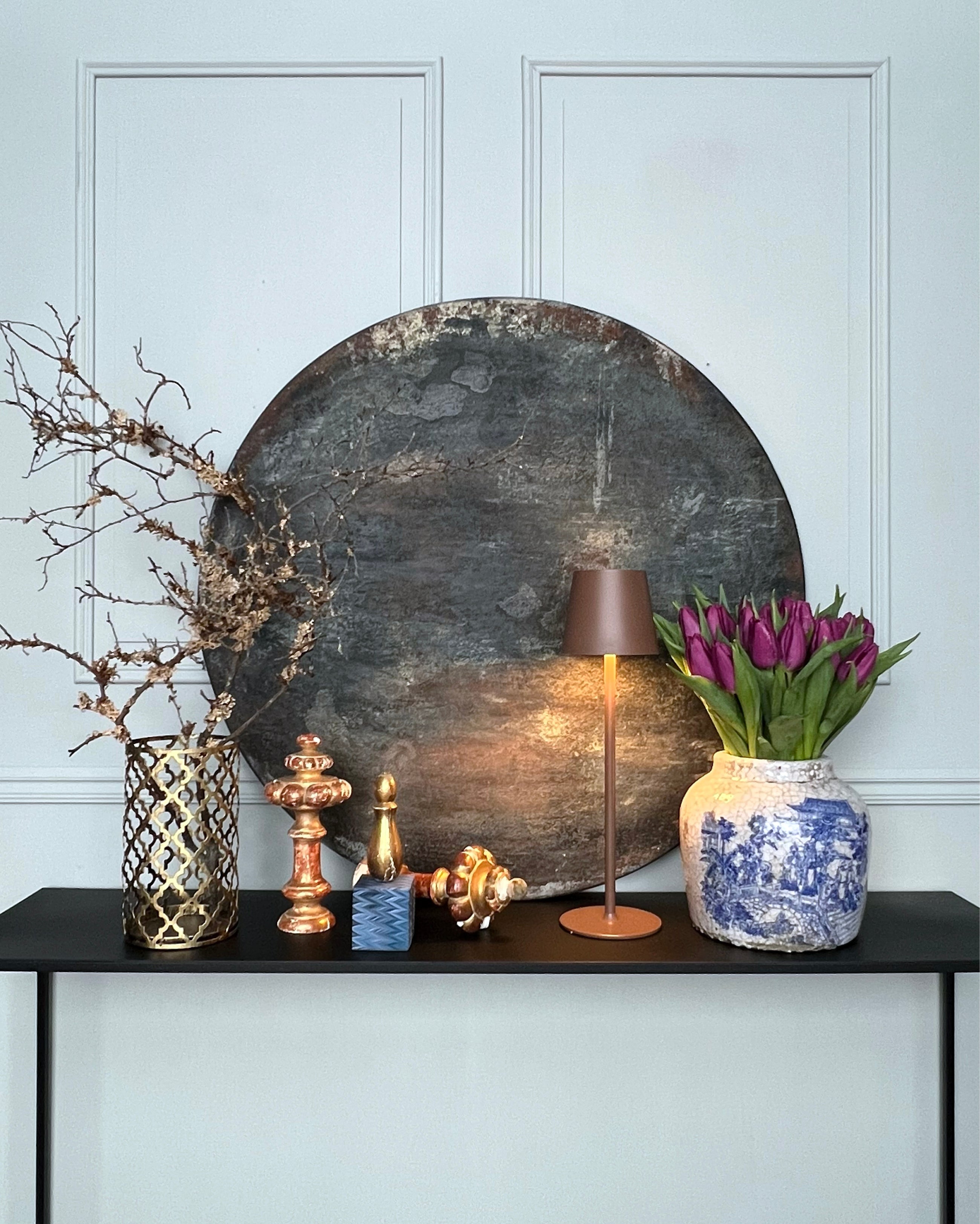 Round abstract artwork displayed in an interior setting, dark patina surface on wood, PURE PATINA – Dark