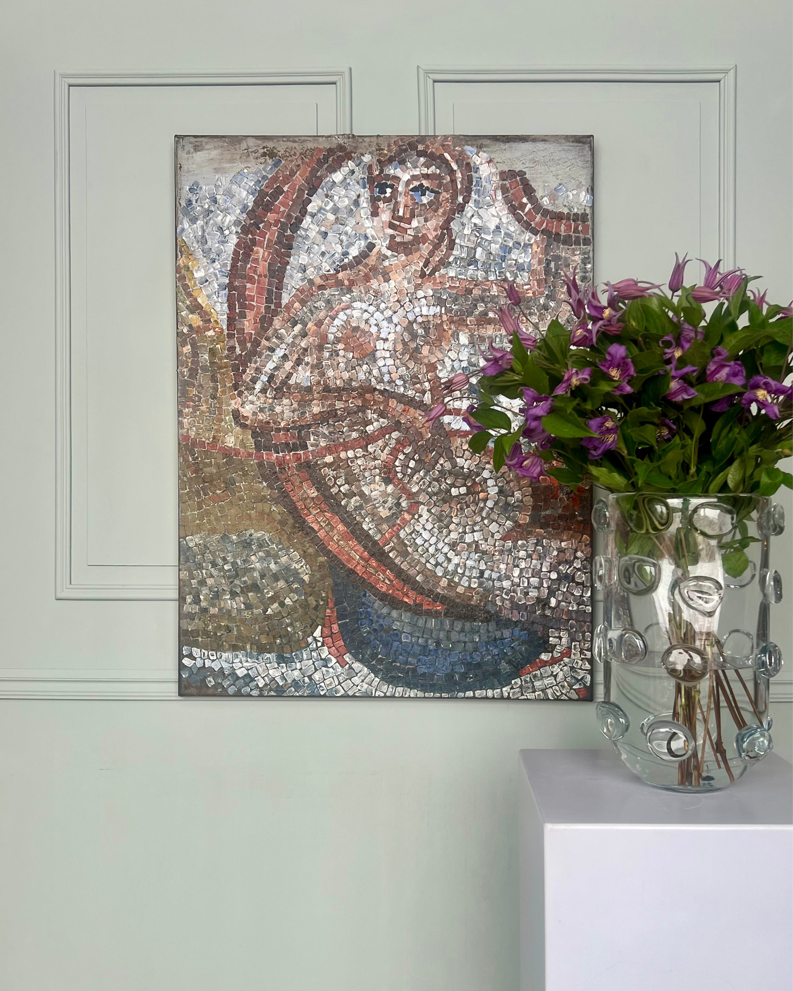 Abstract mosaic painting styled with flowers, glass objects and neutral architectural background.