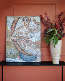 Contemporary mosaic artwork displayed in an elegant interior with classical objects and candlelight.