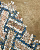 Close-up of abstract mosaic painting showing hand-painted square elements and mineral surface texture.
