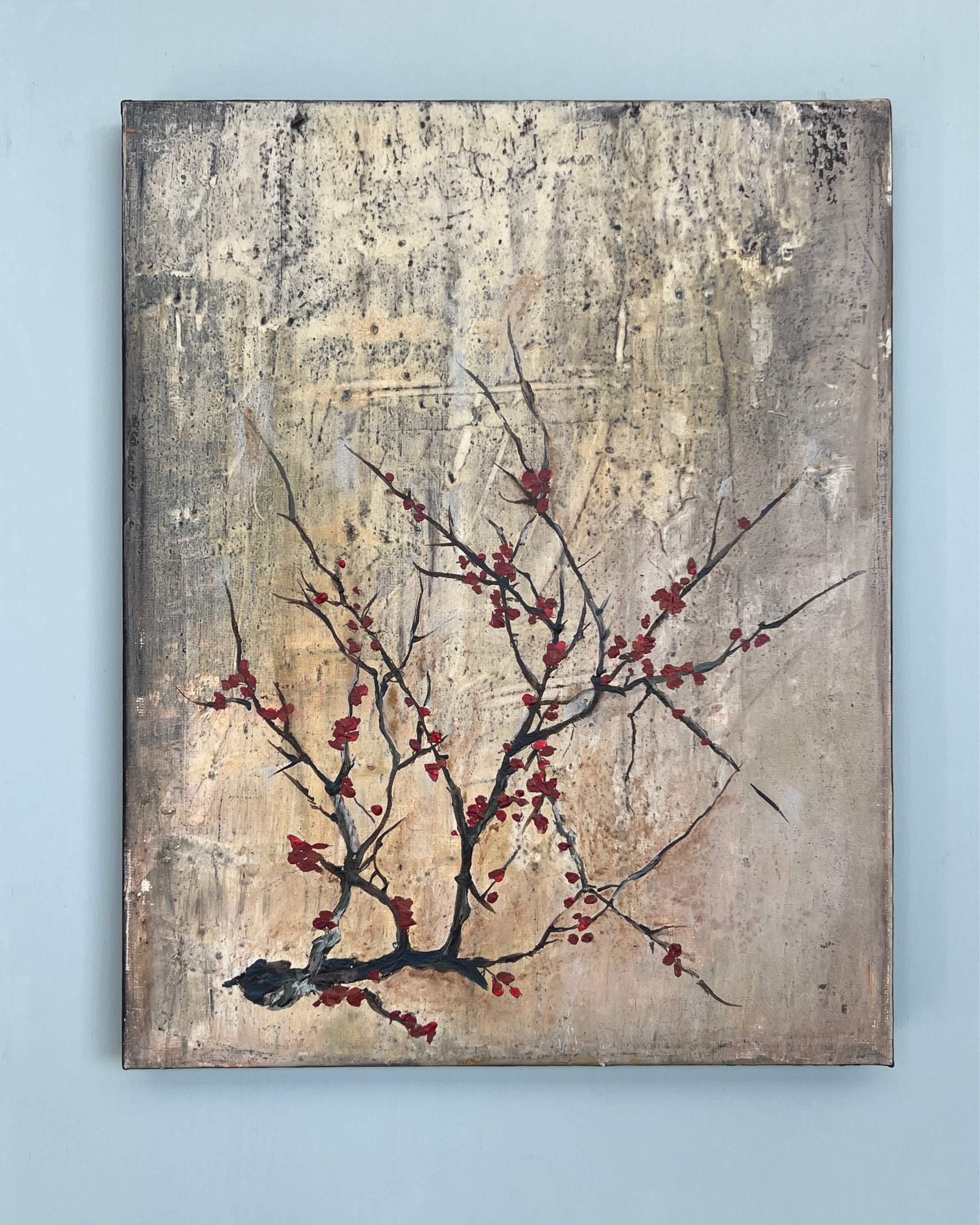 Original square painting displayed on a white wall, featuring a fine branch with red blossoms against a textured grey patina background.