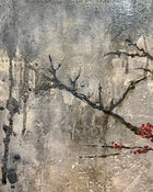 Close-up detail of textured mixed media surface with delicate dark branches and small red blossoms on a grey layered background.